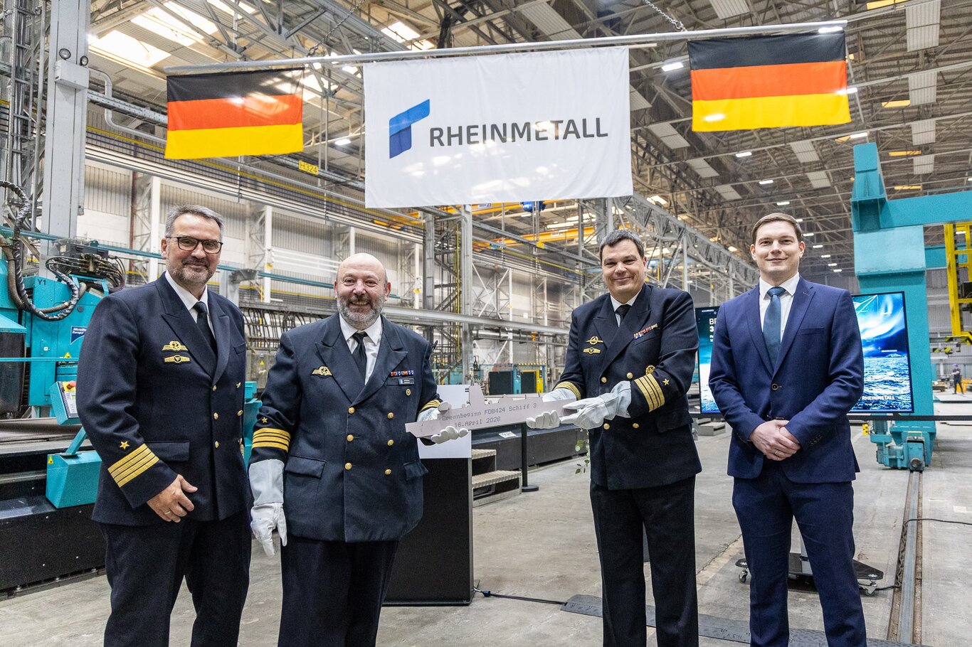 First Steel Cutting Ceremony for the third FDB424 intelligence vessel on 16 April 2026 at the Peene-Werft. From left: Captain (OF-5) Dietrich Esfeld, Project Manager for FDB 424 intelligence vessel, Commander (OF-4) Omar de Stefano, Commander (OF-4) Peter-Christian Wienss and Florian Lahl, Rheinmetall Project Manager for FDB 424 intelligence vessel